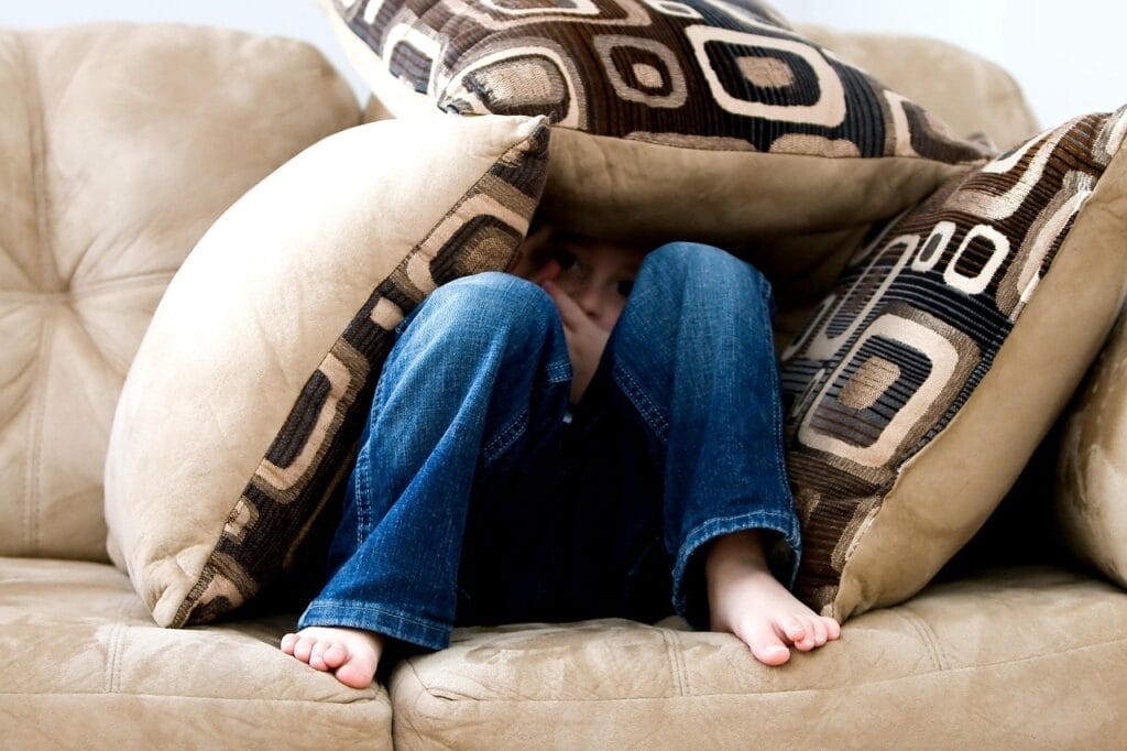 little boy, hiding, sad, child, fear, pillows, couch, pillow fort, bare feet, hide, hide and seek, brown fear, brown couch, sad, fear, fear, fear, fear, fear