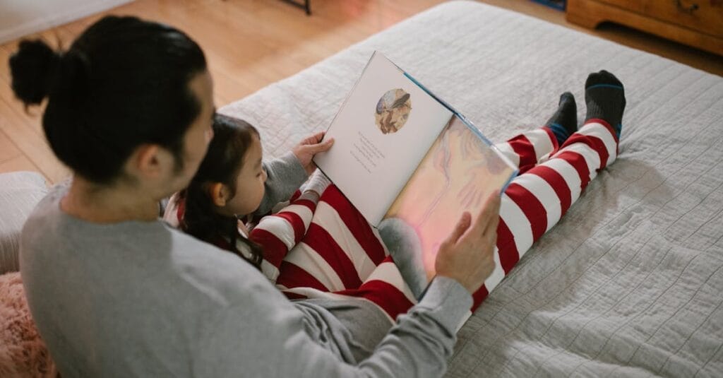 Father and daughter sharing a cozy bedtime story in a warm, home setting.