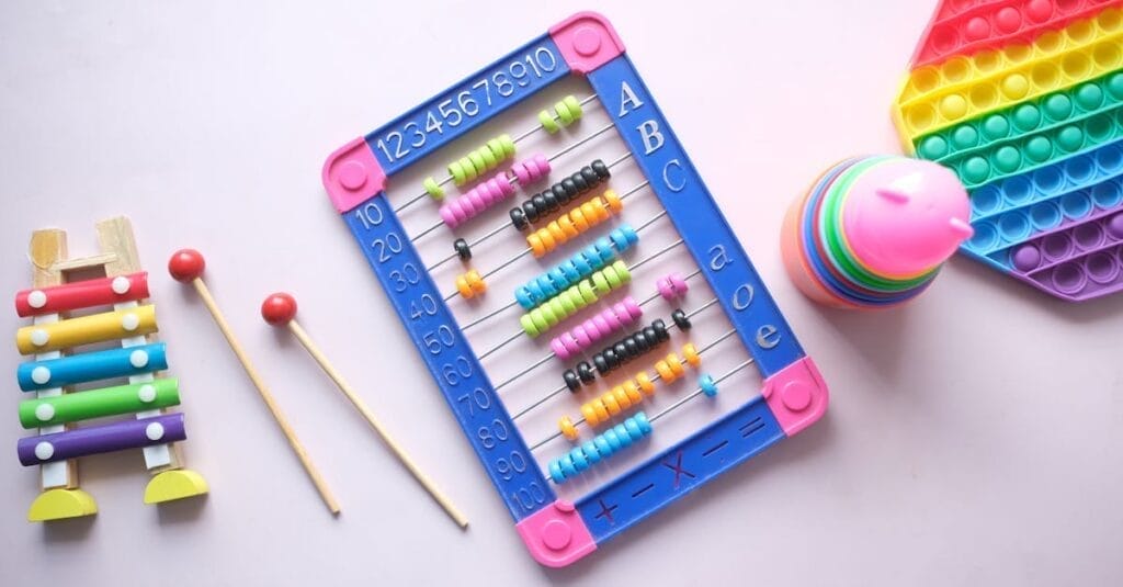 A vibrant display of educational toys including an abacus, xylophone, and stacking cups for children.