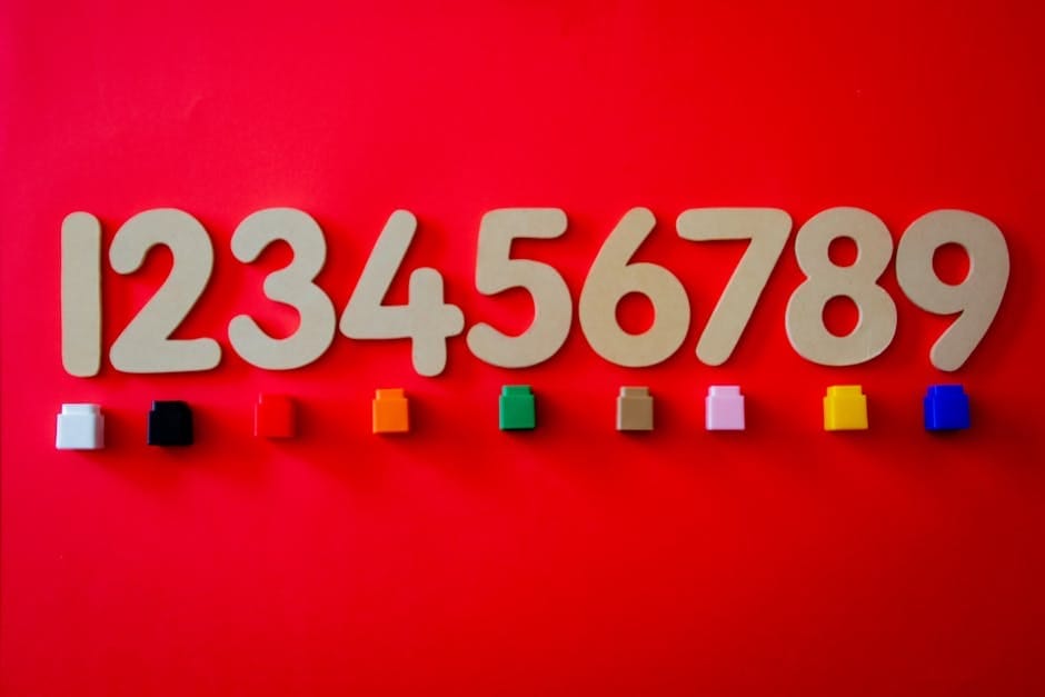 Wooden numbers with colorful cubes on a vibrant red background.