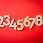 Creative display of numbers one to nine on a vibrant red background, ideal for educational materials.