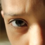 Detailed close-up of a child's eyes, capturing focus and curiosity.