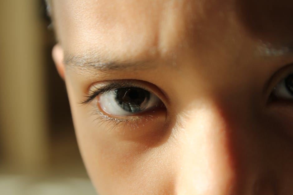 Detailed close-up of a child's eyes, capturing focus and curiosity.