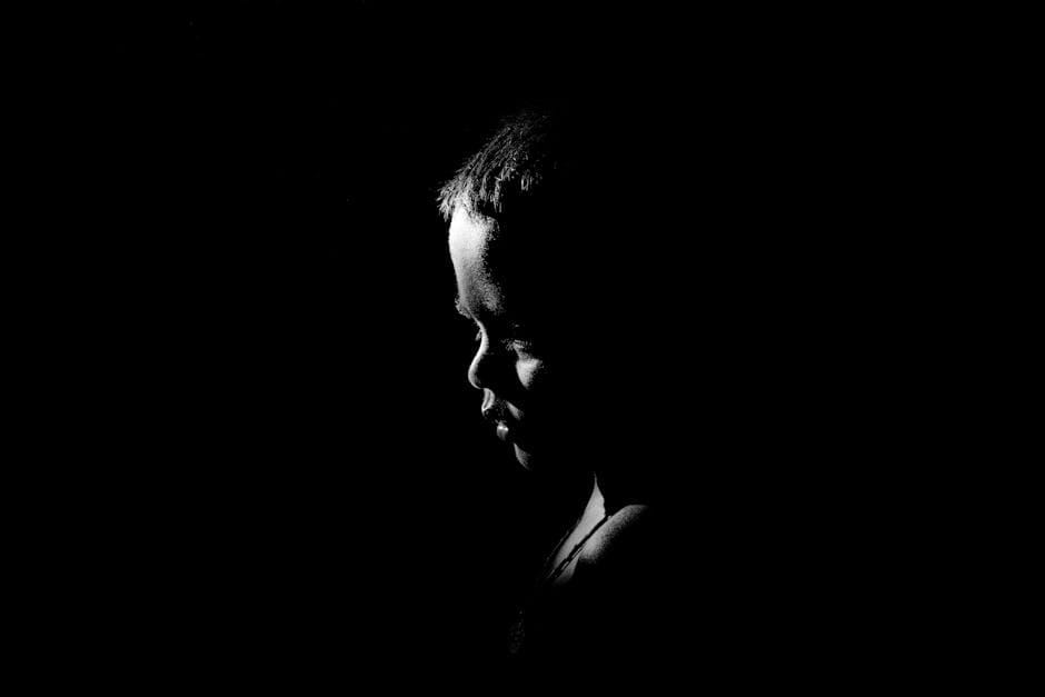 Captivating silhouette of a child in dramatic black and white lighting.