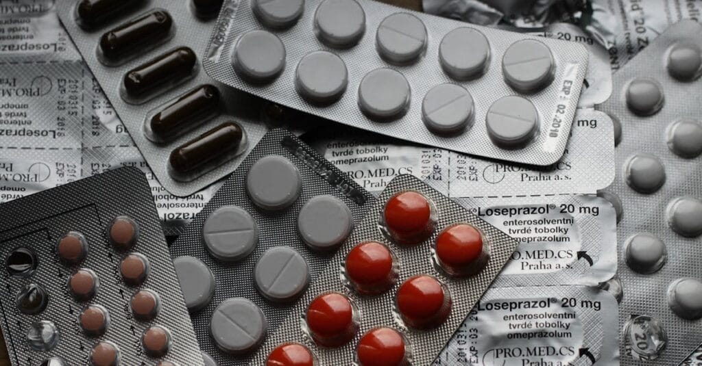 Close-up of various pills in blister packs showcasing medical and healthcare themes.