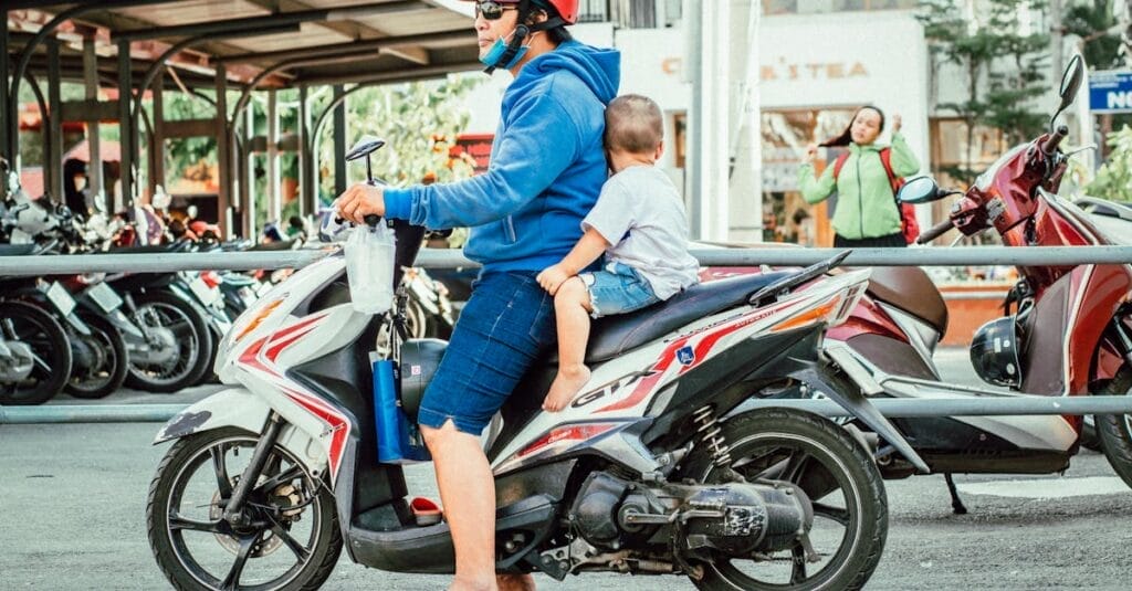 Father and son on a scooter in a busy street, embracing modern urban life.