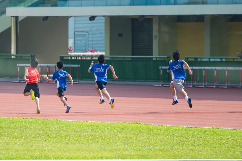 Boys running on a track during a sunny day in New Territories, Hong Kong.