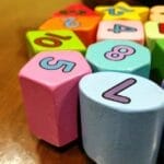 Close-up of colorful wooden blocks with numbers for educational fun.