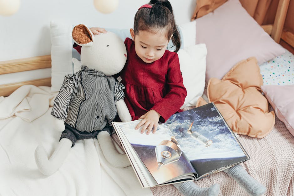 Child reading a picture book with a stuffed toy in a cozy bedroom setting.