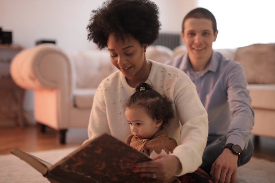 A loving family shares a special moment reading a book together indoors.