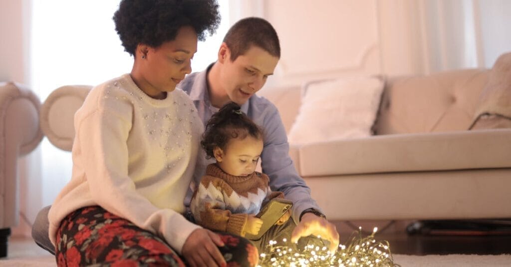 A family enjoys quality bonding time with string lights in their cozy living room.