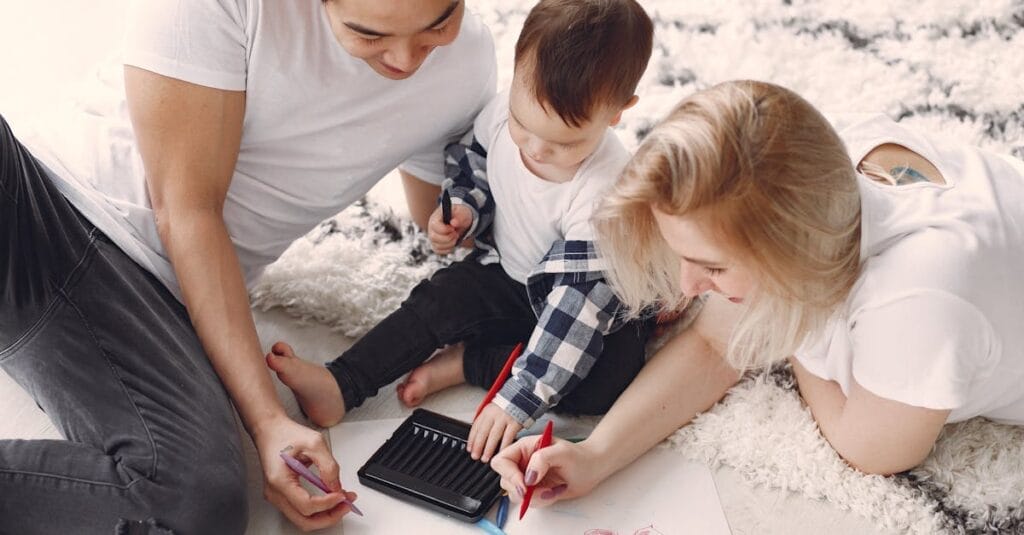 Parents and child enjoying drawing together on the floor, creating memories.