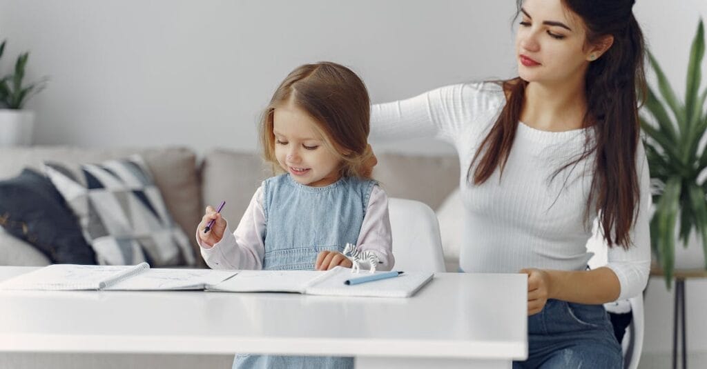 A loving mother helps her daughter with homework at home, fostering a nurturing learning environment.