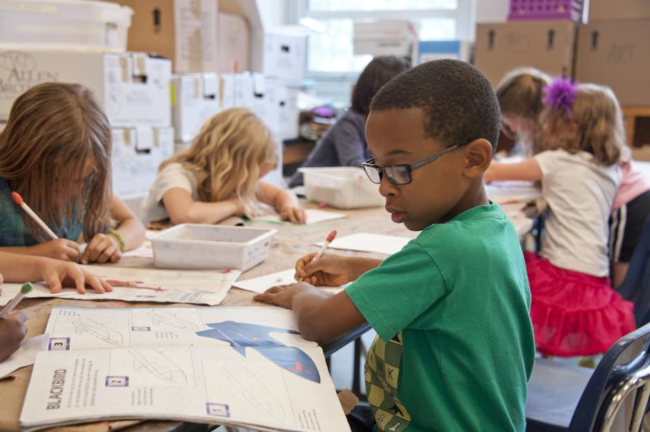 Group of children focused on educational activities in a classroom setting.