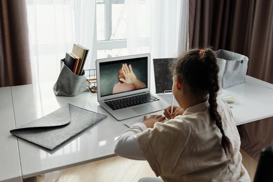 Young girl participating in an online learning session from home during the day.