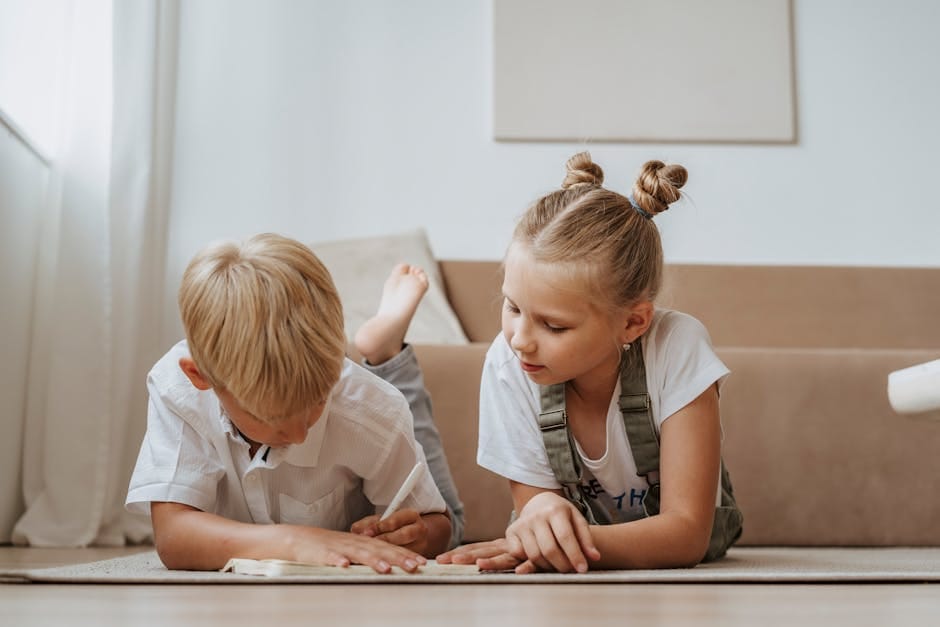 Two children focusing on homework together indoors, fostering sibling togetherness.