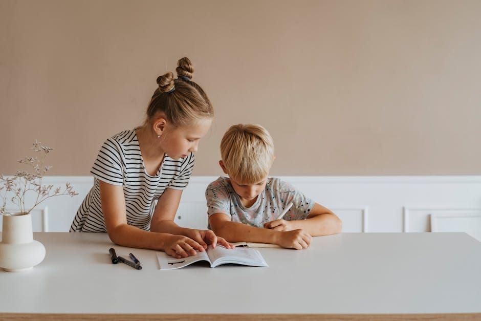 Two children studying together at home with books, emphasizing learning and concentration.