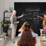 A teacher and students in a classroom during a geometry lesson, focused and engaging.