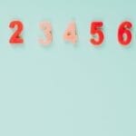 Bright plastic numbers on a blue background with ample copy space, ideal for educational themes.