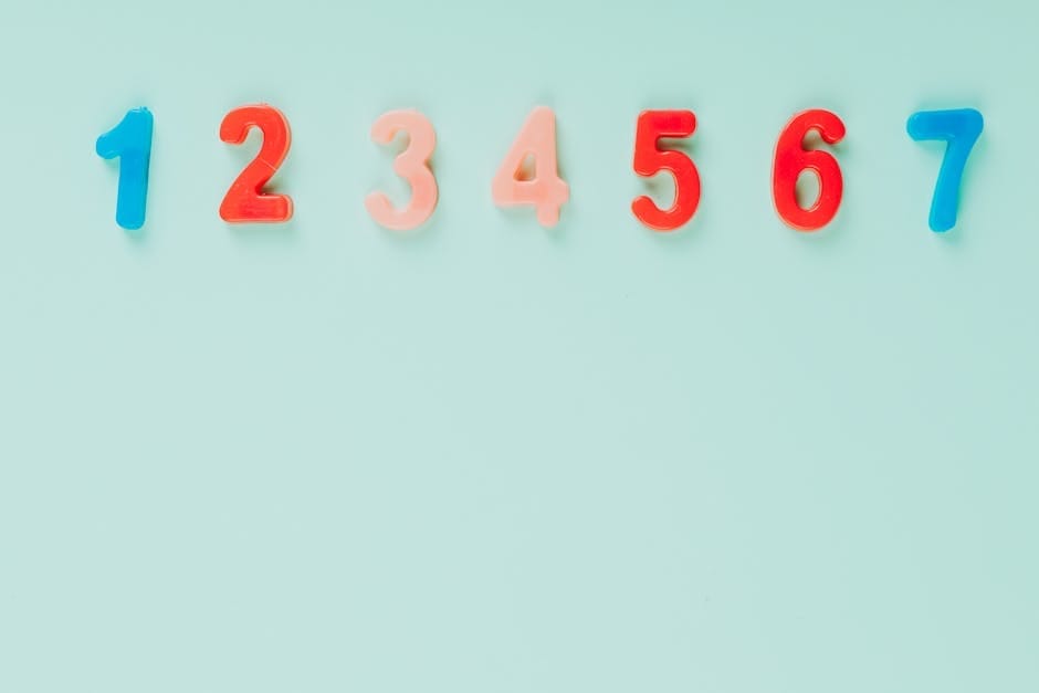 Bright plastic numbers on a blue background with ample copy space, ideal for educational themes.