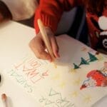 Children crafting heartfelt letters to Santa, full of creativity and holiday cheer.