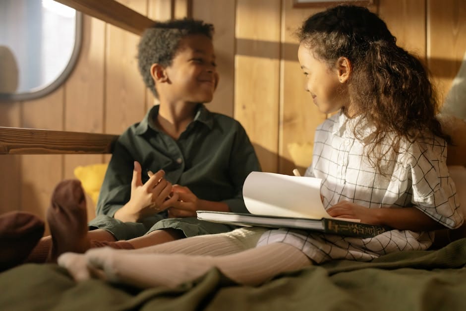 Two children enjoying a cozy reading session indoors, sharing moments of joy.