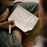 Family enjoying a cozy indoor moment, creating a checklist together with focused energy.