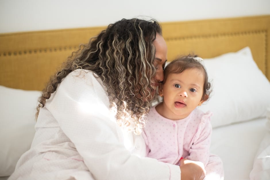 A joyful mother and child sharing a tender moment on a sunny morning indoors.