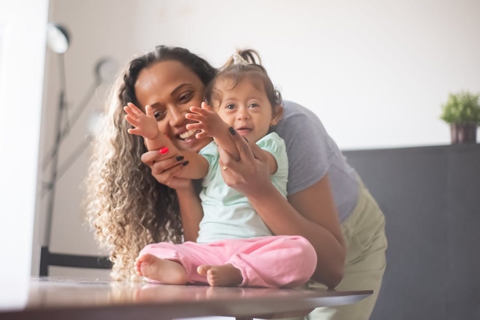 A joyful mother and her child sharing a moment of happiness and affection indoors.