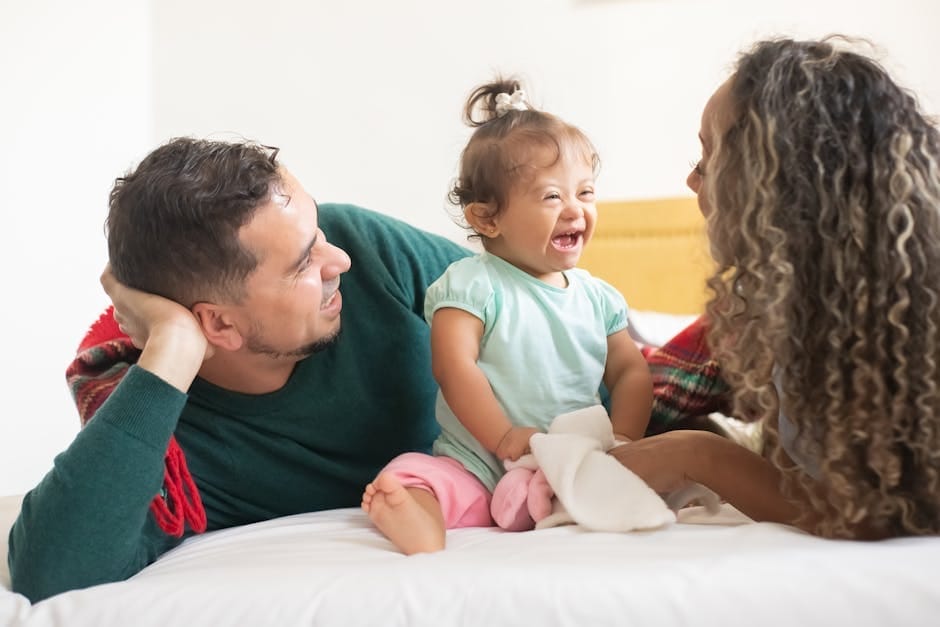 Smiling family enjoying quality time together in a cozy bedroom setting, capturing warmth and love.