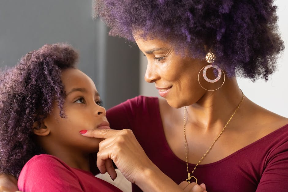 A mother and daughter share a tender moment full of love and connection indoors.