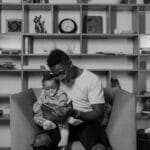 A father and child reading together in a cozy, book-filled room showcasing bonding and family time.