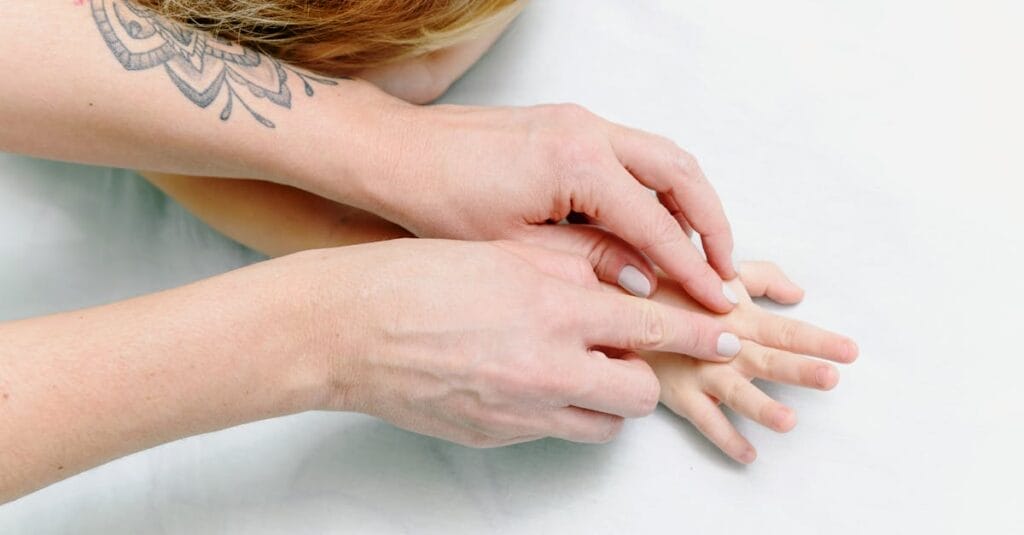 Close-up of a child receiving a comforting hand massage for relaxation and care.