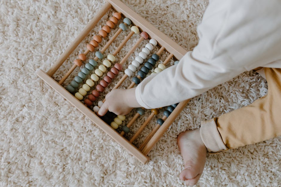 A young child interacts with a colorful wooden abacus, exploring learning through play.