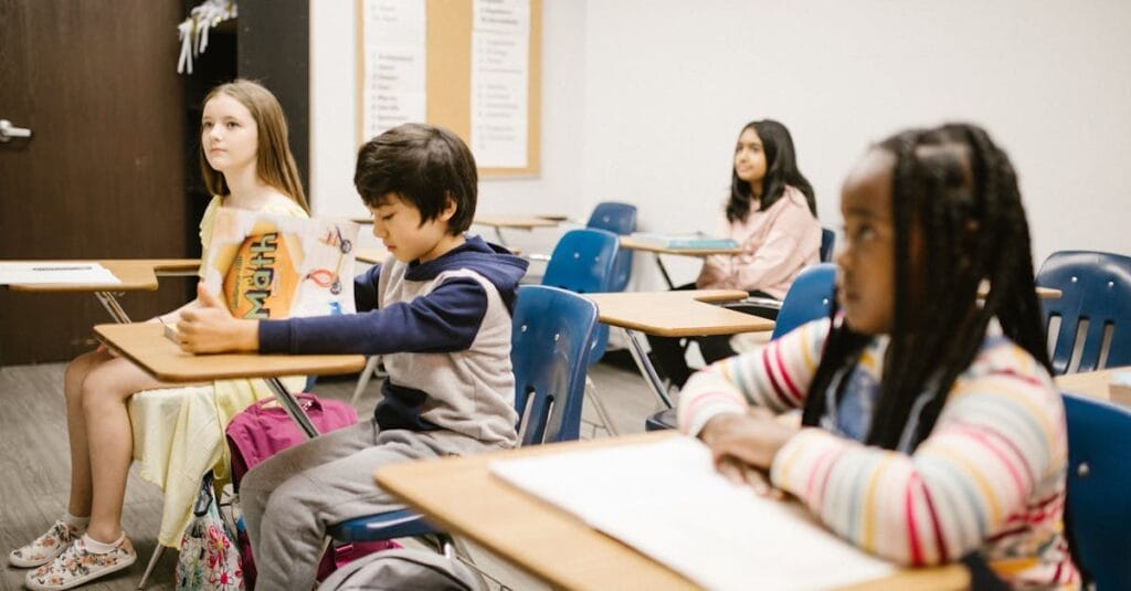 Children focused on a lesson in a diverse classroom environment fostering inclusivity.