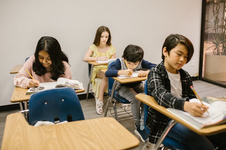 Children focused on writing and learning in a classroom environment.