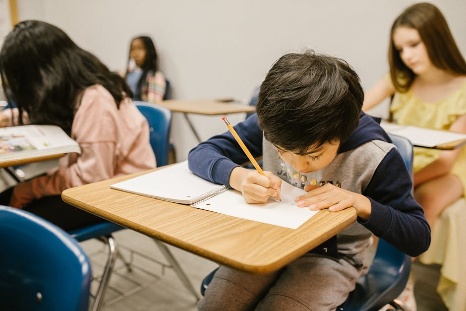 A group of children focused on writing and studying in a classroom setting, emphasizing learning and education.