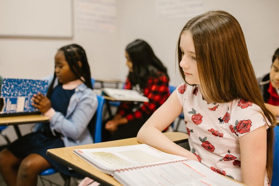 Diverse group of children studying in a classroom setting.