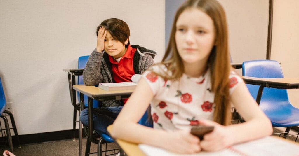 Two students in a classroom setting, focused on their studies.