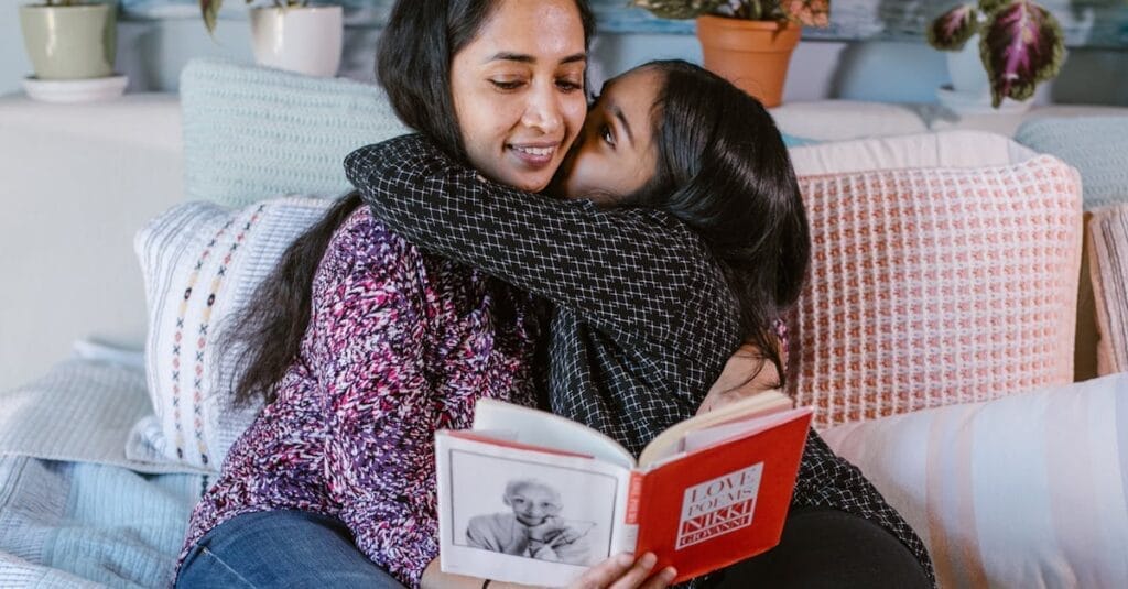 A loving mother and daughter share a tender moment reading together on a cozy bed.