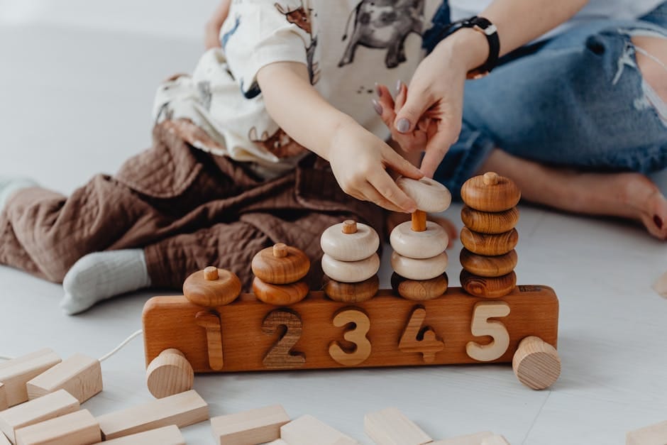 A mother and child engage in playful educational activities with wooden toys, focusing on numbers.