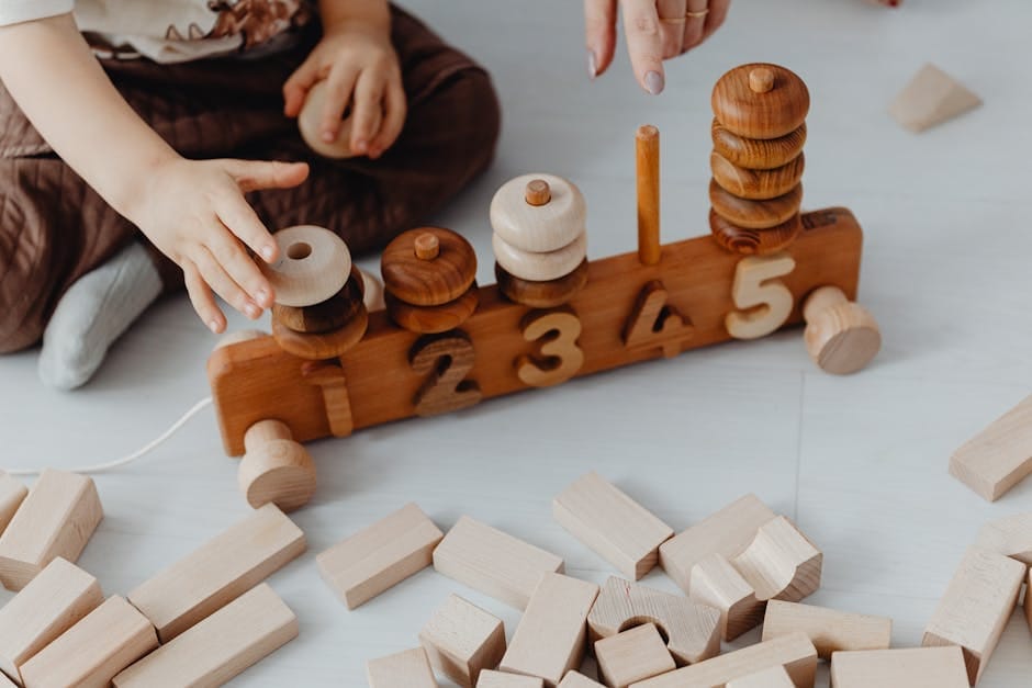 Child engaging with wooden blocks and train toy for learning numbers interactively.