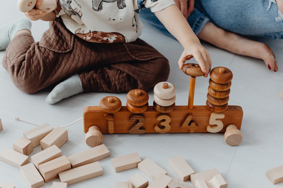 A child engaging with wooden educational toys, counting blocks indoors.