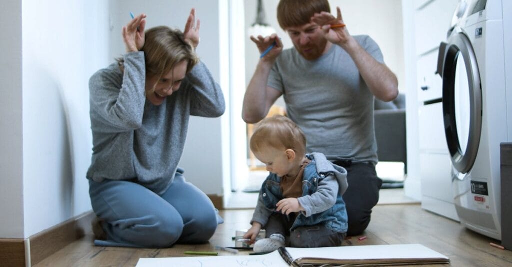 A joyful family moment with parents and baby drawing together on the floor, capturing precious memories.