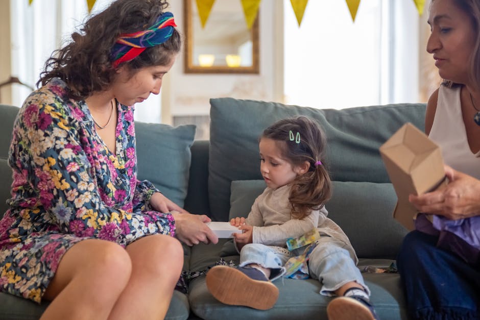 Mother and child sharing a tender moment with a gift on a cozy couch setting.