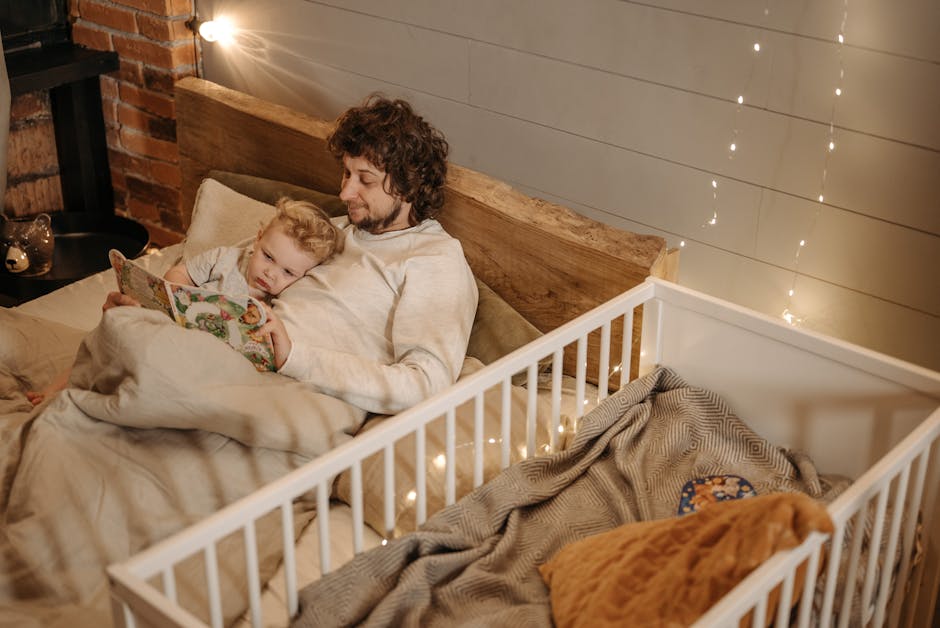 A father and child enjoy a bedtime story together in a warmly lit bedroom.