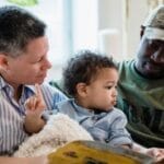 Diverse family enjoying a cozy reading session on the couch together.