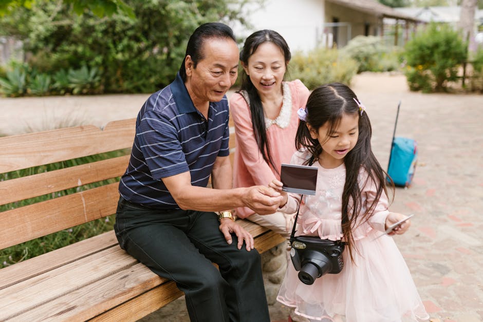 Asian family bonding while exploring photography in a park. Capturing joyful moments together.