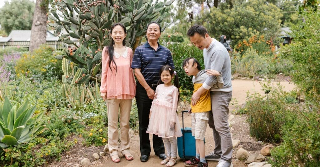 A joyful Asian family enjoys a day outdoors in a lush garden, promoting inclusion and togetherness.