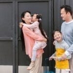 Asian family embracing and enjoying time together outdoors, showcasing love and inclusion.